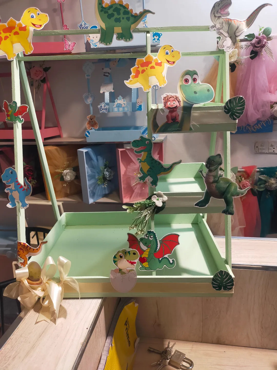 Customized Dinosaur Baby Gift Basket with colorful dinosaur characters and decorations.
