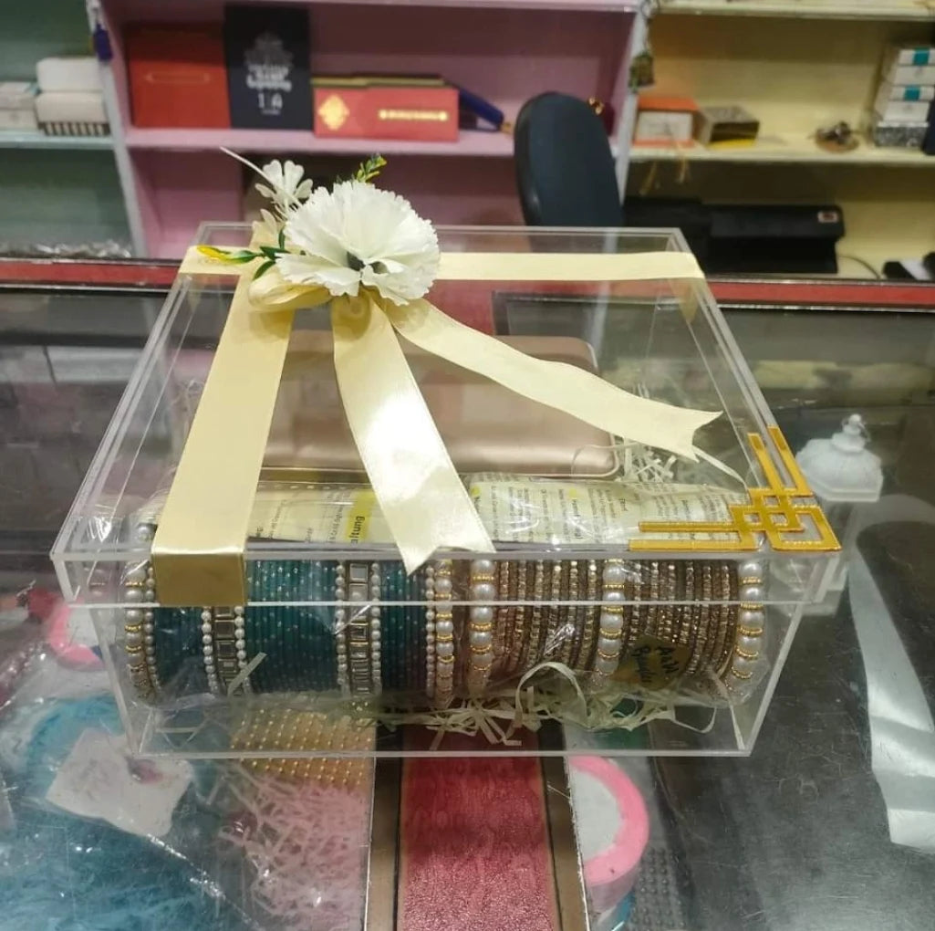 Acrylic wedding gift box with bangles, decorated with flower and ribbon for packaging in Pakistan.